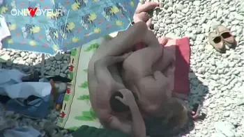 Beach Voyeur. Mature couple fucking under the shining sun