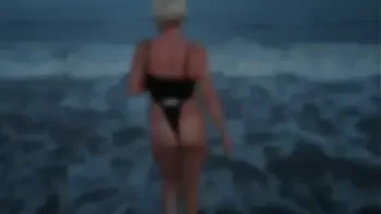 Blonde shows tits and sucks cock on a public beach