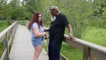 Nerdy Milf strokes and suck blk dick in the Park