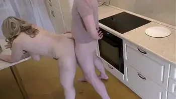 A mature housewife decided to diversify her day and engaged in anal sex in the kitchen