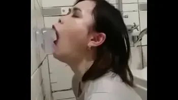 Asian deepthroating a dildo