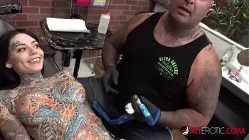 Tiger Lilly gets a forehead tattoo while nude