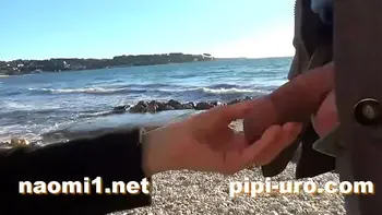public pissing couple on a beach