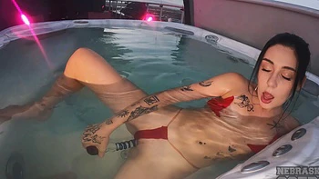 A sexy girl has sex with herself in the jacuzzi using a dildo