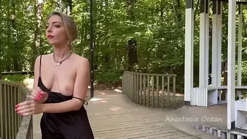 The girl topless is walking in the park in public