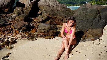 Sizzling Candice flaunts her curves in a skimpy bikini on sunny shores
