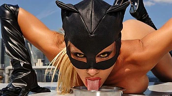 Cat woman Sandy Fantasy poses naked on a roof top and drinks milk